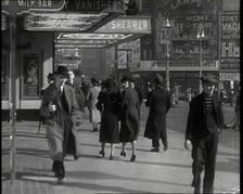 Men and Women Walking Through Leicester Square With the Leicester Corner Restaurant..., 1939. Creator: British Pathe Ltd.