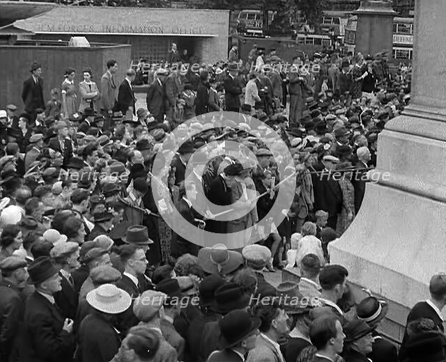 Crowds watching a Military Band in Trafalgar Square, 1940. Creator: British Pathe Ltd.