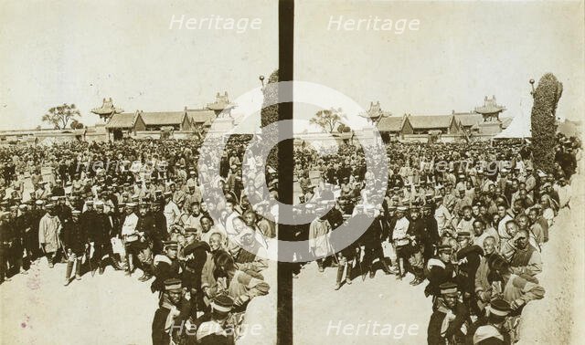 A crowd of Japanese soldiers; Chinese coolies in right foreground, Manchuria, c1905. Creator: Underwood & Underwood.