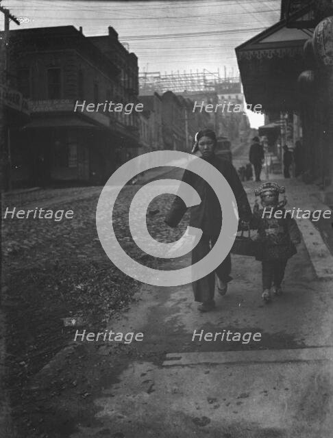 Carrying New Year's presents, Chinatown, San Francisco, between 1896 and 1906. Creator: Arnold Genthe.