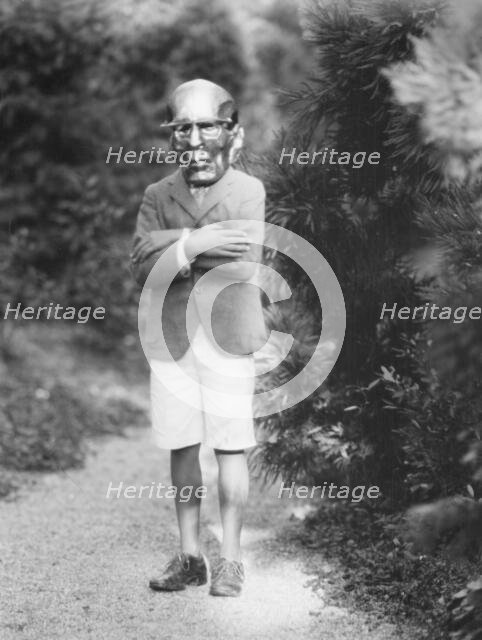 Person wearing a mask made by W.T. Benda, 1925 Sept. 20. Creator: Arnold Genthe.