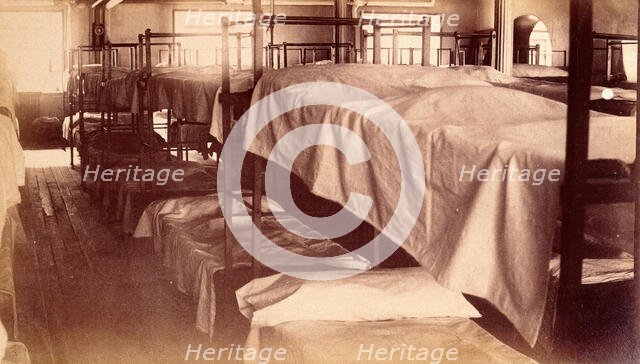 Bellevue Hospital, New York City: a dormitory with bunk beds, 1885-1898. Creator: Unknown.