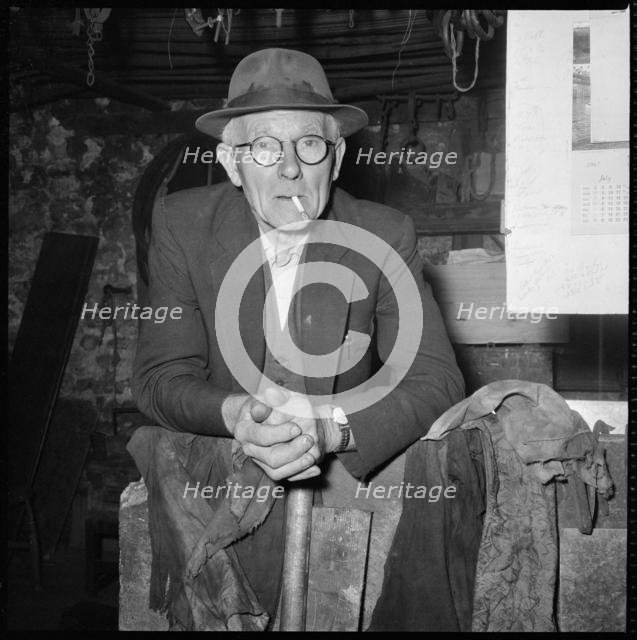Elderly man posed in a workshop, 1967. Creator: Eileen Deste.