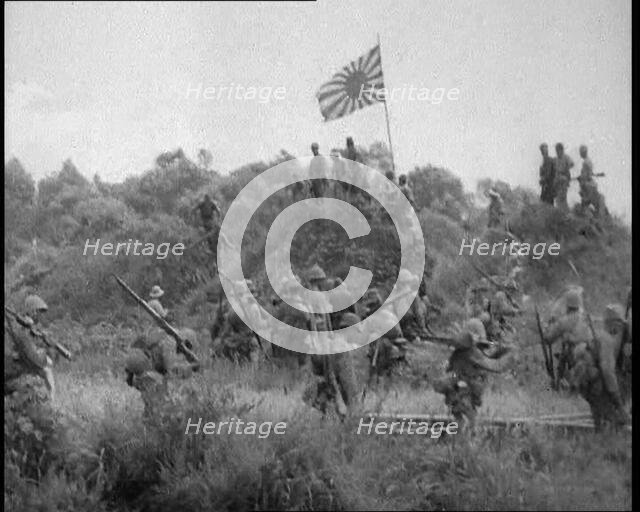 Japanese Soldiers Gathering Around the Japanese Flag, 1933. Creator: British Pathe Ltd.