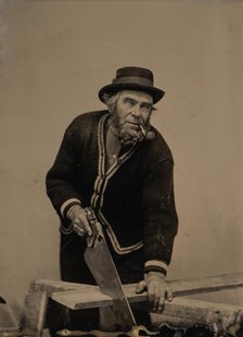 Carpenter Sawing a Plank of Wood, 1880s-90s. Creator: Unknown.