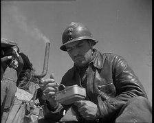 French Soldiers Eating a Meal in a Dug Out, 1940. Creator: British Pathe Ltd.