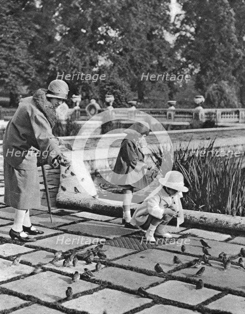 Children feeding the sparrows in Hyde Park, London, 1926-1927. Artist: Unknown