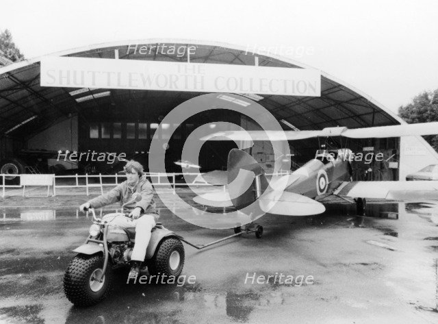 A Honda all terrain cycle pulling a vintage biplane, 1982. Artist: Unknown