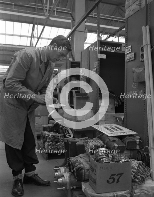 Warehouseman checking stock in the stores at Bestwood Colliery, North Nottinghamshire, 1962. Artist: Michael Walters