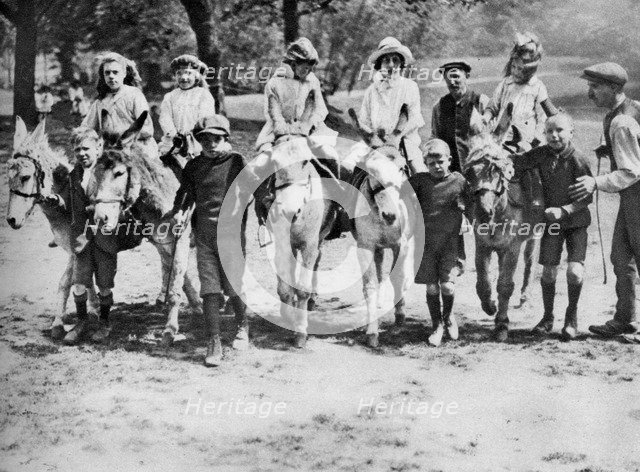 A donkey ride on a bank holiday on Hamstead Heath, London, 1926-1927. Artist: Unknown