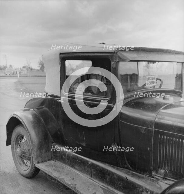 During the cotton strike, a striking picker applies for an emergency food grant, Shafter, CA, 1938. Creator: Dorothea Lange.