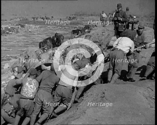 Male Japanese Soldiers Hauling a Cart up a Beach Near Shanghai, 1937. Creator: British Pathe Ltd.