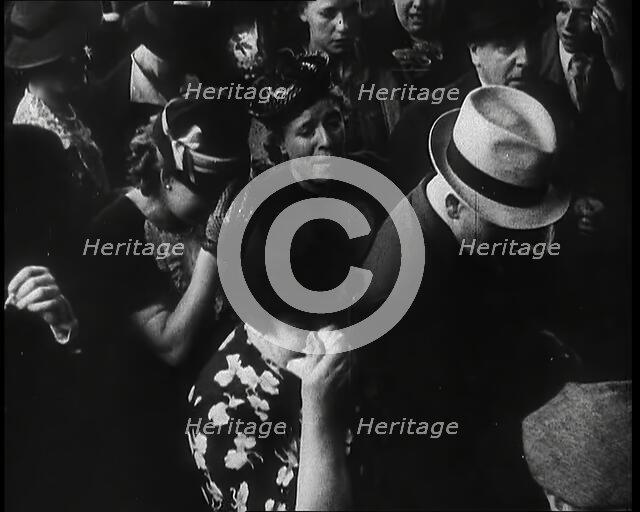 British Women and Men on a Crowded Railway Platform and Several Who Are Looking Upset, 1939. Creator: British Pathe Ltd.