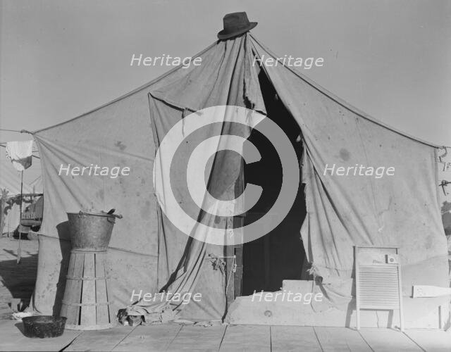 One of a row of tents, home of a pea picker, near Calipatria, Imperial Valley, CA, 1939. Creator: Dorothea Lange.
