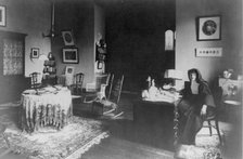 Georgetown Convent, Washington, D.C. - nun seated at desk in furnished room, not after 1892. Creator: Frances Benjamin Johnston.