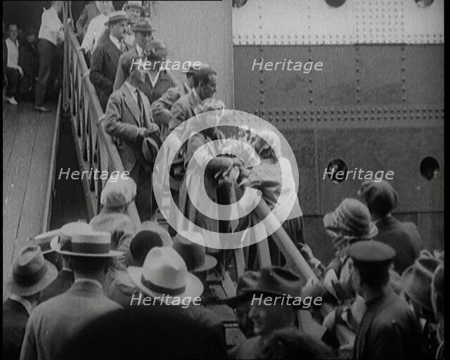 Mary Pickford and Douglas Fairbanks Senior Walking Down the Gangplank to Disembark from an..., 1920. Creator: British Pathe Ltd.