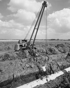 Workers laying a section of the Fens gas pipeline, Norfolk, 10/08/1967. Creator: John Laing plc.