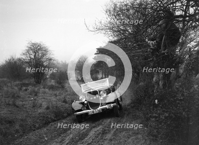 Ford V8 of H Hillcoat at the Sunbac Colmore Trial, near Winchcombe, Gloucestershire, 1934. Artist: Bill Brunell.