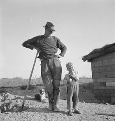 Mr. Dougherty and one of the children, Warm Springs district, Malheur County, Oregon, 1939. Creator: Dorothea Lange.