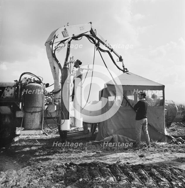 A view of welding taking place along the Fens gas pipeline, Norfolk, 10/08/1967. Creator: John Laing plc.