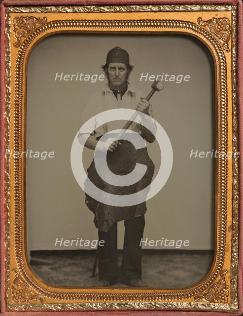 Man Gripping Sledgehammer, Wearing Leather Half Apron and Cap, 1850s-60s. Creator: Unknown.