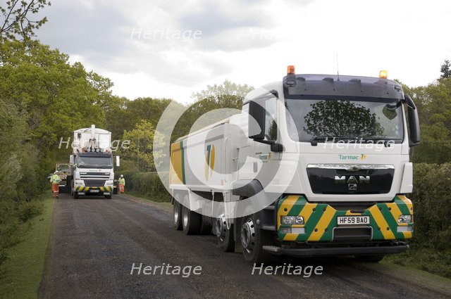 Road resurfacing work repairing potholes Artist: Unknown.