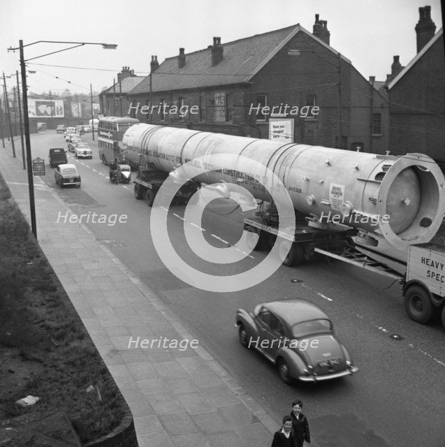 An absorption tower being transported by road, Dukenfield, Manchester, 1962. Artist: Michael Walters