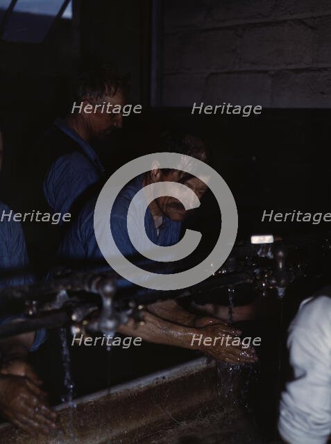 John Sabados washing up after a day's work..., Proviso yard of C & NW RR, Chicago, Ill., 1943. Creator: Jack Delano.
