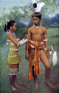'Young Iban or Sea Dayaks people in gala attire, Borneo', 1922. Artist: Dr Charles Hose