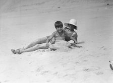Taylor, Fenton, Mrs., and child, at the beach, 1931 Creator: Arnold Genthe.