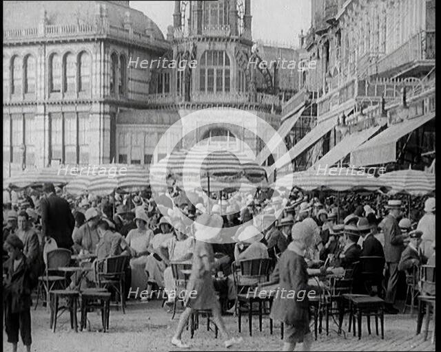 Scene from the Film 'The Compulsory Husband':  Crowds of Holiday Makers Sitting at Out..., 1920s. Creator: British Pathe Ltd.