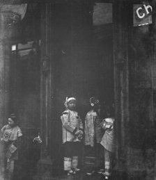 Three girls standing in a doorway, Chinatown, San Francisco, between 1896 and 1906. Creator: Arnold Genthe.
