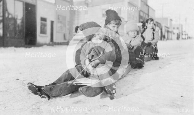 Children sleigh riding, between c1900 and c1930. Creator: Unknown.