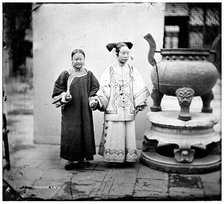 China: a Manchu woman with her maid standing beside a bronze burner, Beijing, 1869. Creator: John Thomson.