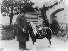 Quentin Roosevelt on pony beside White House policeman, 1905. Creator: Frances Benjamin Johnston.