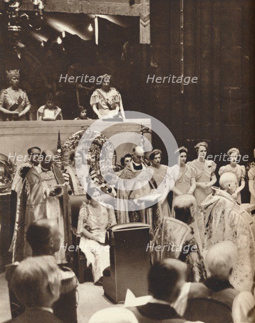 'Queen Elizabeth looks on as her husband is crowned on the day of his coronation', 1937. Creator: Unknown.