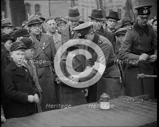 Child Holding a Hand Grenade, 1930s. Creator: British Pathe Ltd.