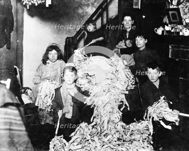 Making party streamers at home, London, c1900. Artist: Unknown