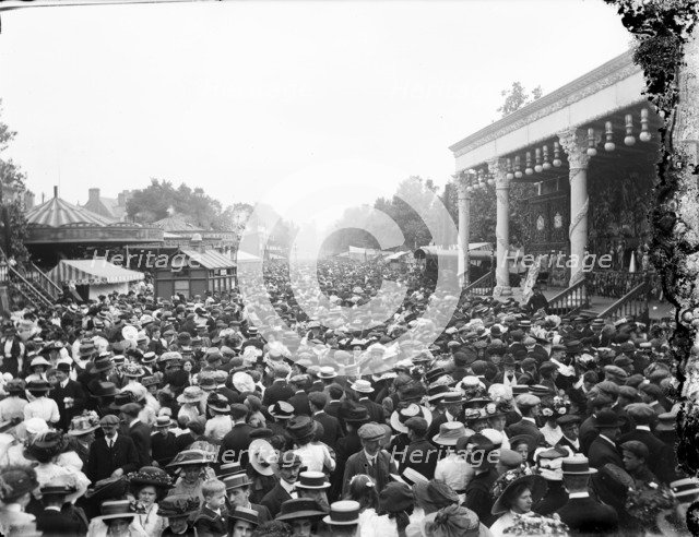 Crowded street showing a stage and carousel at St Giles Fair, Oxford, Oxfordshire, c1860-c1922. Artist: Henry Taunt