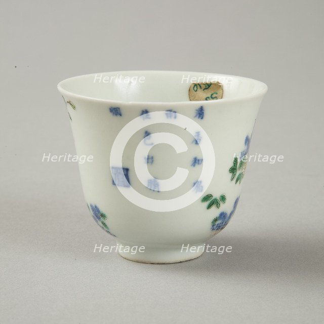 Underglaze blue month cup with polychrome enamelled decoration of a prunus tree. Artist: Unknown.