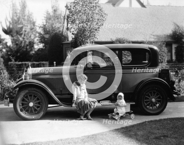 Stan Laurel at the wheel of 1927 Hupmobile with his wife Lois and daughter Lois  Artist: Unknown.