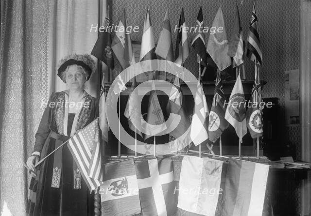 Mrs. Carrie Chapman Catt with Flags of 22 Nations, 1917. Creator: Harris & Ewing.