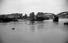 A rowing eight approaches Barnes Bridge, Chiswick, London, c1945-c1965. Artist: SW Rawlings