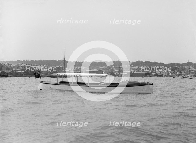 Saunders' motor launch at anchor, 1914. Creator: Kirk & Sons of Cowes.