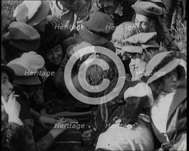 Crowds of Female Actors Wearing Period Costumes Smoking Cigarettes Whilst Filming..., 1920s. Creator: British Pathe Ltd.