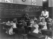 Grade school, Washington, D.C. - children drawing and cutting rectangles, triangles, etc., (1899?). Creator: Frances Benjamin Johnston.