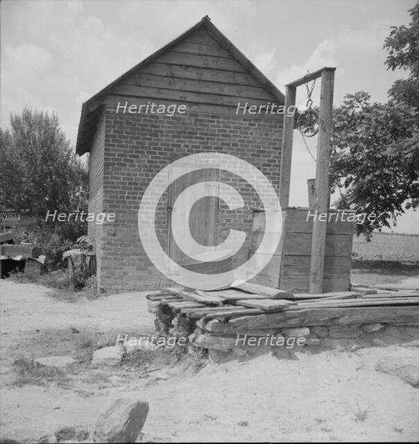 Well and old plantation smokehouse, Chesnee, South Carolina, 1937. Creator: Dorothea Lange.