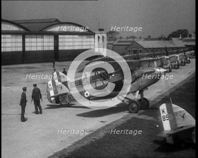 RAF Biplanes Taxiing Across a Field at tended to by Their Aircrews, 1933. Creator: British Pathe Ltd.