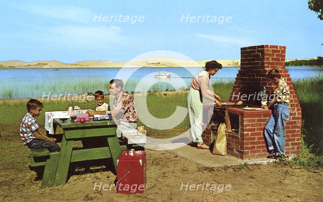 Family having a picnic on the beach by a lake, Michigan, USA, 1955. Artist: Unknown