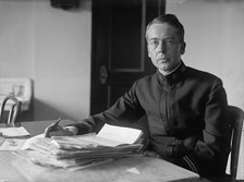 J.P. Auld, U.S.N. at Desk, 1917. Creator: Harris & Ewing.